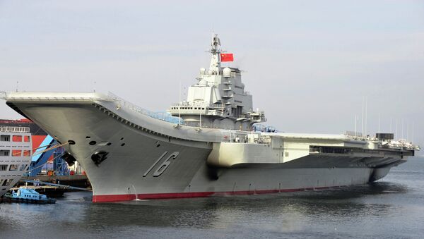 In this undated photo released by China's Xinhua News Agency, China's aircraft carrier Liaoning berths in a port of China. China formally entered its first aircraft carrier into service on Tuesday, Sept. 25, 2012 - Sputnik International