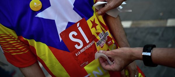 A pro-independence Basque puts a sticker on a T-shirt which reads, ''Yes for the Independence'', during a march to support the pro-independence Catalonia movement, in Pamplona, northern Spain, Saturday, Sept. 11, 2015 - Sputnik International