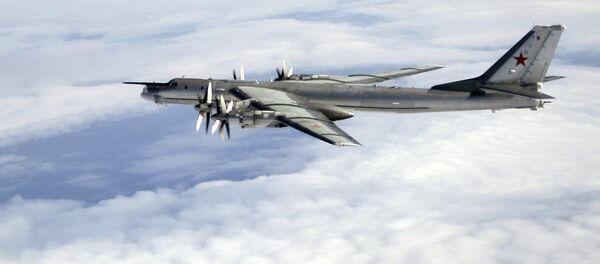 A Tu-95 being escorted by an RAF Typhoon A Tu-95 being escorted by an RAF Typhoon - Sputnik International