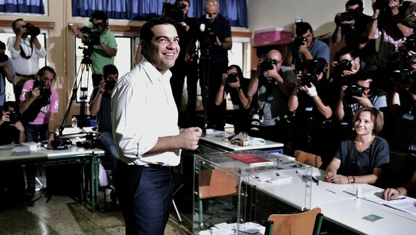 Greek radical-left Syriza party leader and former Prime Minister Alexis Tsipras smiles prior to cast his vote at a polling station in central Athens on September 20, 2015 - Sputnik International