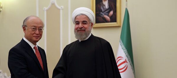 Iranian President Hassan Rouhani, center, welcomes U.N. nuclear chief Yukiya Amano at the start of their meeting in Tehran, Iran, Sunday, Sept. 20, 2015 - Sputnik International