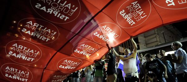 Supporters of Syriza wave a giant flag reads in Italian The other Europe with Tsipras'' at party’s main electoral center in Athens, Sunday, Sept. 20, 2015 Supporters of Syriza wave a giant flag reads in Italian The other Europe with Tsipras'' at party’s main electoral center in Athens, Sunday, Sept. 20, 2015 - Sputnik International