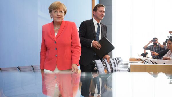 German Chancellor Angela Merkel, left, and government spokesman Steffen Seibert leave after Merkel's annual summer news conference in Berlin, Germany, Monday, Aug. 31, 2015 - Sputnik International
