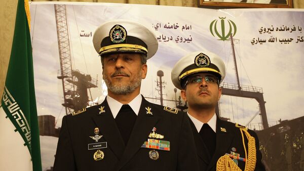 Rear Admiral Habibollah Sayyari (L), commander of the Iranian navy, stands under portraits of Iranian supreme leader Ayatollah Ali Khamenei and late revolutionary founder Ayatollah Khomeini (L) during a press conference at the Iranian embassy in the Syrian capital Damascus on February 28, 2011 - Sputnik International