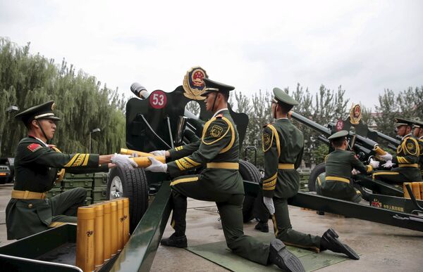Paramilitary policemen and members of a gun salute team prepare to fire cannons during a training session for the upcoming military parade to mark the 70th anniversary of the end of the World War Two, at a military base in Beijing, China, September 1, 2015 Paramilitary policemen and members of a gun salute team prepare to fire cannons during a training session for the upcoming military parade to mark the 70th anniversary of the end of the World War Two, at a military base in Beijing, China, September 1, 2015 - Sputnik International