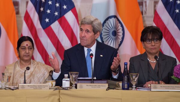 US Secretary of State John Kerry (C) speaks Indian External Affairs Minister Sushma Swaraj (L) during a US-India Strategic & Commercial Dialogue plenary session at the US Department of State in Washington, DC, September 22, 2015, with US Secretary of Commerce Penny Pritzker (R) - Sputnik International