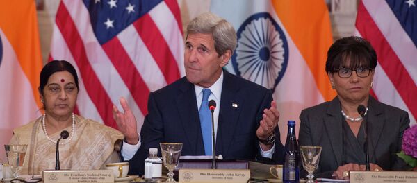 US Secretary of State John Kerry (C) speaks Indian External Affairs Minister Sushma Swaraj (L) during a US-India Strategic & Commercial Dialogue plenary session at the US Department of State in Washington, DC, September 22, 2015, with US Secretary of Commerce Penny Pritzker (R) - Sputnik International