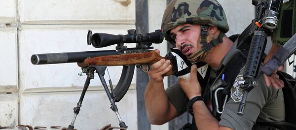 An Israeli border guard aims his sniper rifle during clashes with Palestinian protesters following an anti-Israeli protest after the weekly Friday prayers on September 18, 2015 in the Israeli-controlled area called H2, in the West Bank town of Hebron An Israeli border guard aims his sniper rifle during clashes with Palestinian protesters following an anti-Israeli protest after the weekly Friday prayers on September 18, 2015 in the Israeli-controlled area called H2, in the West Bank town of Hebron - Sputnik International