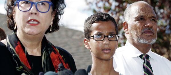 Ahmed Mohamed, 14, center, and his father Mohamed Elhassan Mohamed, right, look on as their attorney Linda Moreno, left, delivers a statement about the arrest of Ahmed during a news conference, Wednesday, September 16, 2015, in Irving, Texas - Sputnik International