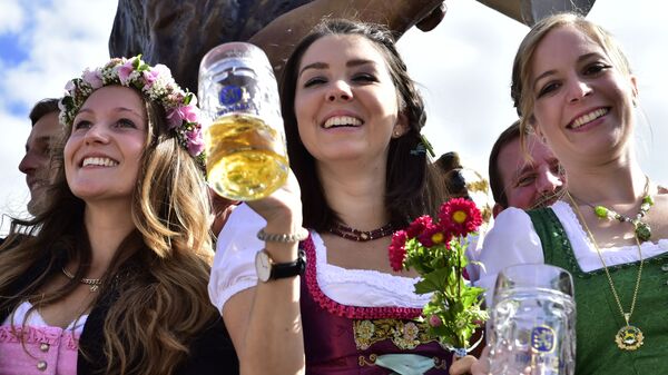 Young women celebrate the opening of the 182. Oktoberfest beer festival in Munich, southern Germany, Saturday, Sept. 19, 2015 - Sputnik International