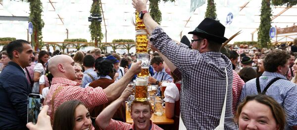 Visitors joke with beer mugs on the first day of the 182nd Oktoberfest in Munich, Germany, September 19, 2015 Visitors joke with beer mugs on the first day of the 182nd Oktoberfest in Munich, Germany, September 19, 2015 - Sputnik International