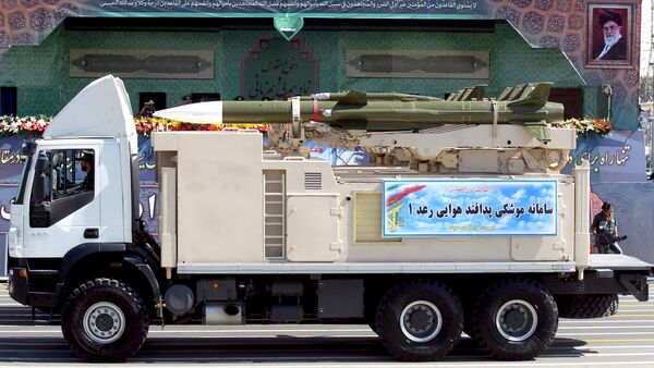 A military truck carrying a Raad missile drives past a picture of Iran's Supreme Leader Ayatollah Ali Khamenei (R) during a parade marking the anniversary of the Iran-Iraq war (1980-88), in Tehran - Sputnik International