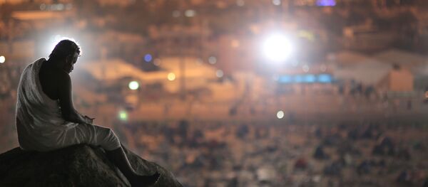 Muslim pilgrim prays on a rocky hill called the Mountain of Mercy, on the Plain of Arafat, near the holy city of Mecca, Saudi Arabia Muslim pilgrim prays on a rocky hill called the Mountain of Mercy, on the Plain of Arafat, near the holy city of Mecca, Saudi Arabia - Sputnik International