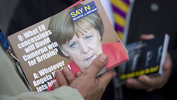 A supporter holds leaflets showing German Chancellor Angela Merkel, as they distribute them in Ramsgate, east of London, as Leader of the UK Independence Party (UKIP) Nigel Farage (not pictured) kicks off their Say No To The EU tour on September 7, 2015, during the party’s referendum campaign. - Sputnik International