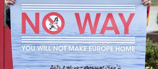 A man holds a banner during a demonstration initiated by right-wing NPD (National Democratic Party of Germany) against the German asylum law and asylum seekers in Riesa, eastern Germany, Tuesday, Aug. 18, 2015. A man holds a banner during a demonstration initiated by right-wing NPD (National Democratic Party of Germany) against the German asylum law and asylum seekers in Riesa, eastern Germany, Tuesday, Aug. 18, 2015. - Sputnik International