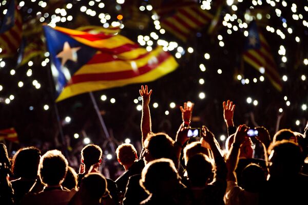 Pro independence supporters wave estelada or pro independence flags during a rally of Junts pel Si or Together for YES in Barcelona, Spain, Friday, Sept. 25, 2015 - Sputnik International