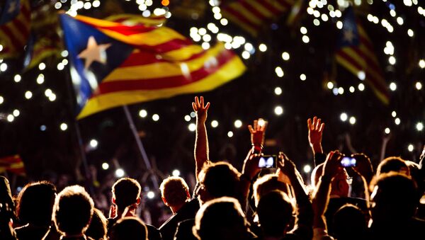 Pro independence supporters wave estelada or pro independence flags during a rally of Junts pel Si or Together for YES in Barcelona, Spain, Friday, Sept. 25, 2015 - Sputnik International