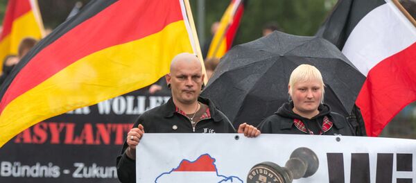 German right-wing supporters of Thuegida, the local group of the PEGIDA movement Patriotic Europeans Against the Islamification of the Occident take part in a march in Suhl, eastern Germany on August 17, 2015. German right-wing supporters of Thuegida, the local group of the PEGIDA movement Patriotic Europeans Against the Islamification of the Occident take part in a march in Suhl, eastern Germany on August 17, 2015. - Sputnik International