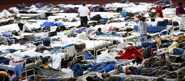Migrants sit on their beds at an improvised temporary shelter in a sports hall in Hanau, Germany, September 24, 2015 Migrants sit on their beds at an improvised temporary shelter in a sports hall in Hanau, Germany, September 24, 2015 - Sputnik International