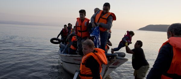 Syrian refugees arrive on a fishing boat from Turkey on the shores of the Greek island of Lesbos , Sunday Sept. 27, 2015 Syrian refugees arrive on a fishing boat from Turkey on the shores of the Greek island of Lesbos , Sunday Sept. 27, 2015 - Sputnik International