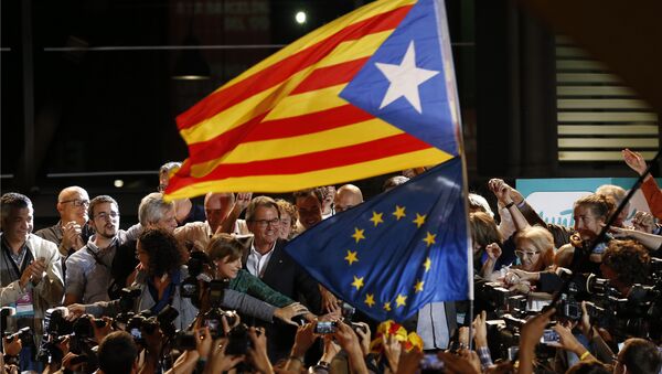 A estelada or pro independence flag and a European Union flag are waved in front of the President of Democratic Convergence of Catalonia Artur Mas, center in front of supporters in Barcelona, Spain, Sunday Sept. 27, 2015 - Sputnik International