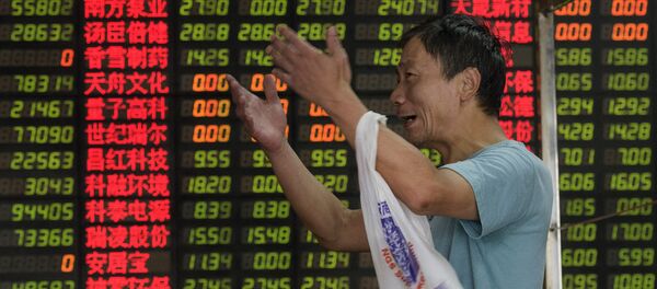 In this file picture taken on September 1, 2015, an investor reacts in front of screens showing stock market movements at a brokerage house in Shanghay In this file picture taken on September 1, 2015, an investor reacts in front of screens showing stock market movements at a brokerage house in Shanghay - Sputnik International
