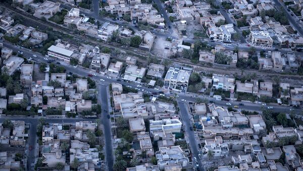 An aerial picture taken on board a helicopter shows a view of the Iraqi capital Baghdad on June 23, 2014 - Sputnik International