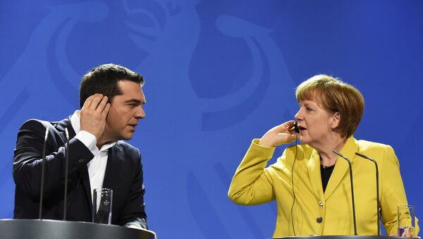 German Chancellor Angela Merkel (R) and Greek Prime Minister Alexis Tsipras hold their earpieces as they address a press conference following talks at the chancellery in Berlin, on March 23, 2015 - Sputnik International