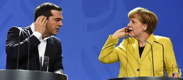 German Chancellor Angela Merkel (R) and Greek Prime Minister Alexis Tsipras hold their earpieces as they address a press conference following talks at the chancellery in Berlin, on March 23, 2015 German Chancellor Angela Merkel (R) and Greek Prime Minister Alexis Tsipras hold their earpieces as they address a press conference following talks at the chancellery in Berlin, on March 23, 2015 - Sputnik International