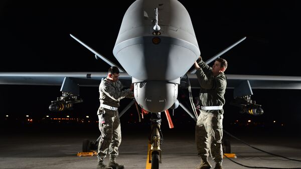 Airman 1st Class Steven (left) and Airman 1st Class Taylor prepare an MQ-9 Reaper for flight during exercise Combat Hammer, May 15, 2014, at Creech Air Force Base, Nev. Reaper crews flew a week-long mission, where they released the GBU-12 Paveway II and AGM-114 Hellfire munitions. Steven and Taylor are MQ-9 Reaper crew chiefs from the 432nd Aircraft Maintenance Squadron. - Sputnik International