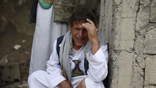 A man cries after some of his relatives were killed in a Saudi-led airstrike in Sanaa, Yemen, Monday, Sept. 21, 2015. - Sputnik International