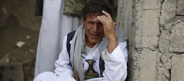 A man cries after some of his relatives were killed in a Saudi-led airstrike in Sanaa, Yemen, Monday, Sept. 21, 2015. - Sputnik International