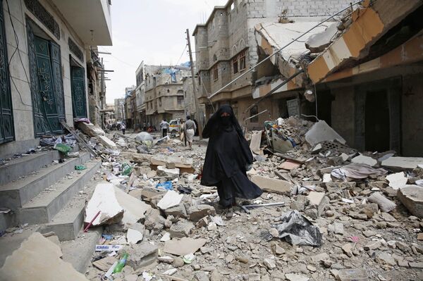 A woman walks amid the rubble of houses destroyed by a Saudi-led airstrike in Sanaa, Yemen, Monday, Sept. 21, 2015 A woman walks amid the rubble of houses destroyed by a Saudi-led airstrike in Sanaa, Yemen, Monday, Sept. 21, 2015 - Sputnik International
