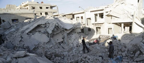 Residents inspect a site damaged by what activists said was a barrel bomb dropped by forces loyal to Syria's president Bashar Al-Assad in Maarat Al-Nouman, south of Idlib, Syria September 29, 2015 Residents inspect a site damaged by what activists said was a barrel bomb dropped by forces loyal to Syria's president Bashar Al-Assad in Maarat Al-Nouman, south of Idlib, Syria September 29, 2015 - Sputnik International
