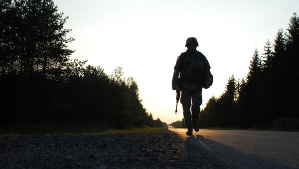 U.S. Army Cpl. Mihai Mocanu of Bravo Company, 2nd Battalion, 6th Infantry Regiment, performs a ruck march during the United States Army Europe Soldier and NCO of the Year Competition Aug. 15, 2007, at the Grafenwoehr Training Area in Germany. - Sputnik International