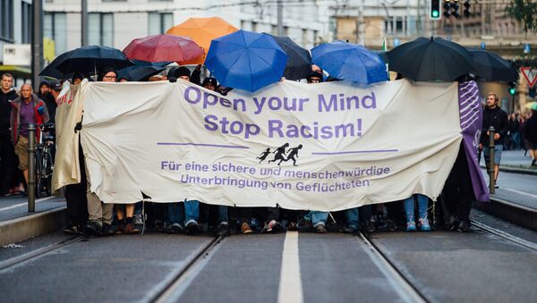 In this Monday July 27, 2015 picture demonstrators march through the city of Dresden, eastern Germany. They carried a banner reading: Open Your Mind - Stop Racism. - Sputnik International