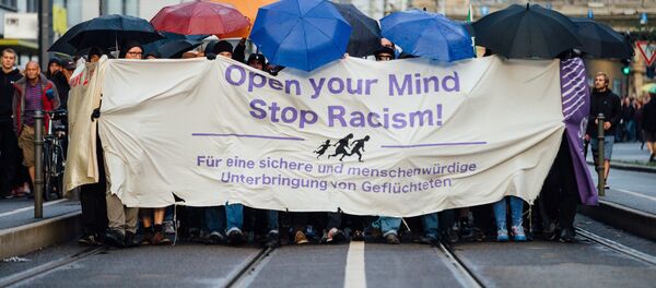 In this Monday July 27, 2015 picture demonstrators march through the city of Dresden, eastern Germany. They carried a banner reading: Open Your Mind - Stop Racism. In this Monday July 27, 2015 picture demonstrators march through the city of Dresden, eastern Germany. They carried a banner reading: Open Your Mind - Stop Racism. - Sputnik International