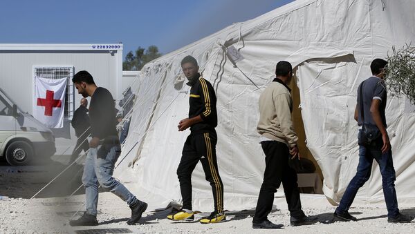 Migrants walk by the tents at a reception camp at Kokkinotrimithia village outside Cyprus' capital Nicosia - Sputnik International