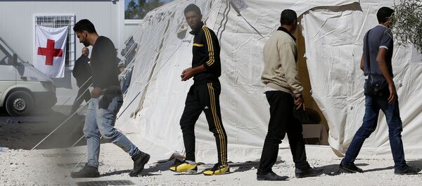 Migrants walk by the tents at a reception camp at Kokkinotrimithia village outside Cyprus' capital Nicosia Migrants walk by the tents at a reception camp at Kokkinotrimithia village outside Cyprus' capital Nicosia - Sputnik International