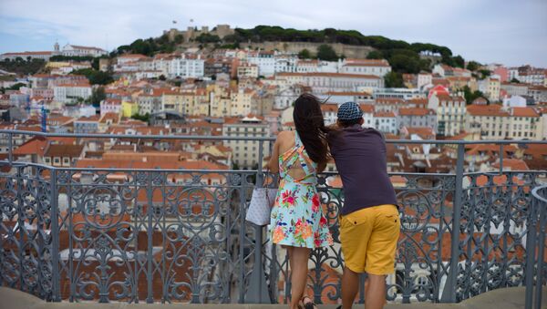 A young couple enjoys the view from the top of Lisbon's 1902 Santa Justa lift. File photo - Sputnik International