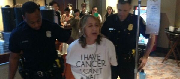 Atlanta police arrest health advocate and cancer survivor Zahara Heckscher outside of negotiations for the Trans-Pacific Partnership. Atlanta police arrest health advocate and cancer survivor Zahara Heckscher outside of negotiations for the Trans-Pacific Partnership. - Sputnik International