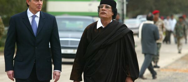 Libyan leader Col. Moammar Gadhafi, at right, with Britain's Prime Minister Tony Blair as they meet outside Tripoli, in Libya, Thursday, March, 25, 2004. - Sputnik International
