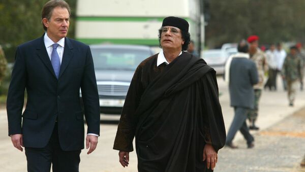 Libyan leader Col. Moammar Gadhafi, at right, with Britain's Prime Minister Tony Blair as they meet outside Tripoli, in Libya, Thursday, March, 25, 2004. - Sputnik International