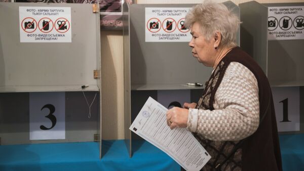 A woman during voting at a ballot station in Bishkek where elections to Kyrgyzstan's one-house parliament are taking place - Sputnik International