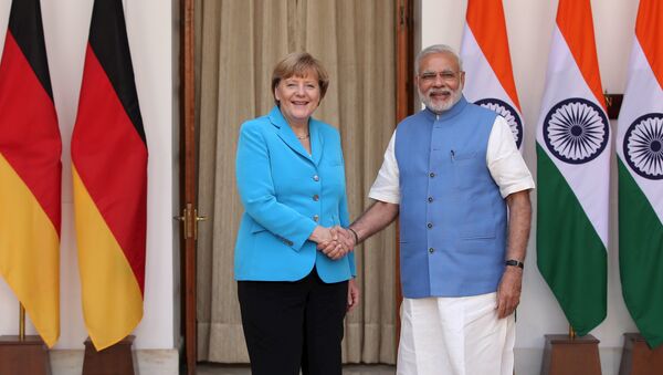 German Chancellor Angela Merkel (L) shakes hands with India’s Prime Minister Narendra Modi during a photo opportunity ahead of their meeting at Hyderabad House in New Delhi, India, October 5, 2015 - Sputnik International