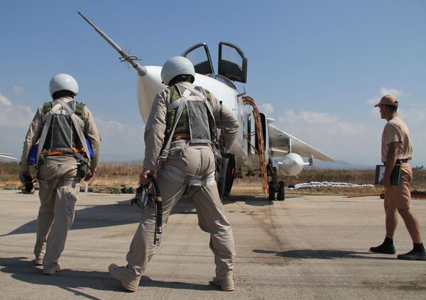 Russian pilots near a Su-24 aircraft before a mission, at the Khmeimim airbase in Syria Russian pilots near a Su-24 aircraft before a mission, at the Khmeimim airbase in Syria - Sputnik International