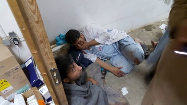 Afghan staff react inside a Medecins Sans Frontieres (MSF) hospital after an air strike in the city of Kunduz, Afghanistan in this October 3, 2015 - Sputnik International