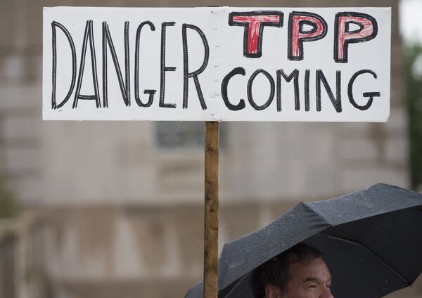 Demonstrators protest against the legislation to give US President Barack Obama fast-track authority to advance trade deals, including the Trans-Pacific Partnership (TPP), during a protest march on Capitol Hill in Washington, DC, May 21, 2015. Demonstrators protest against the legislation to give US President Barack Obama fast-track authority to advance trade deals, including the Trans-Pacific Partnership (TPP), during a protest march on Capitol Hill in Washington, DC, May 21, 2015. - Sputnik International
