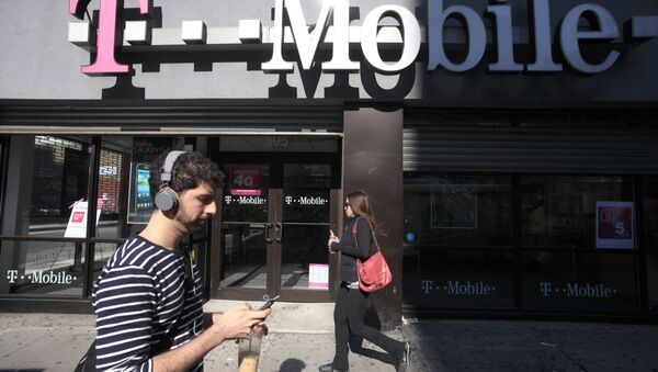 In this Sept. 12, 2012 file photo, a man uses a cellphone as he passes a T-Mobile store in New York. - Sputnik International