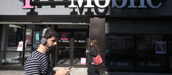 In this Sept. 12, 2012 file photo, a man uses a cellphone as he passes a T-Mobile store in New York. - Sputnik International